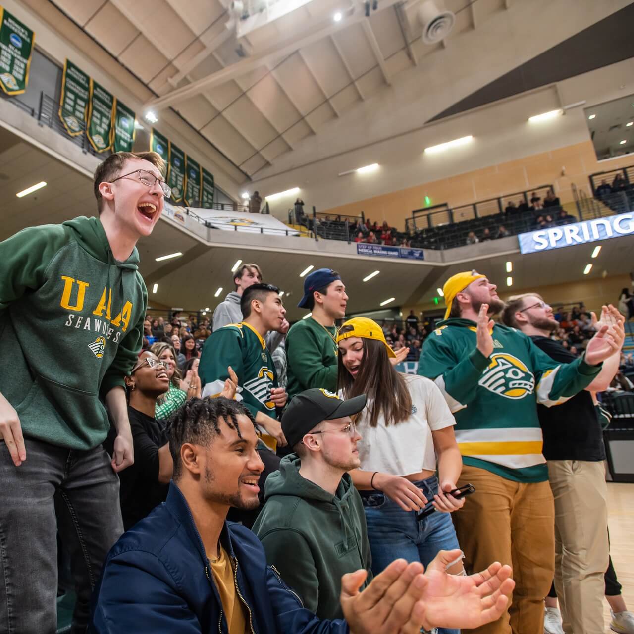 UAA students cheering together at a home game