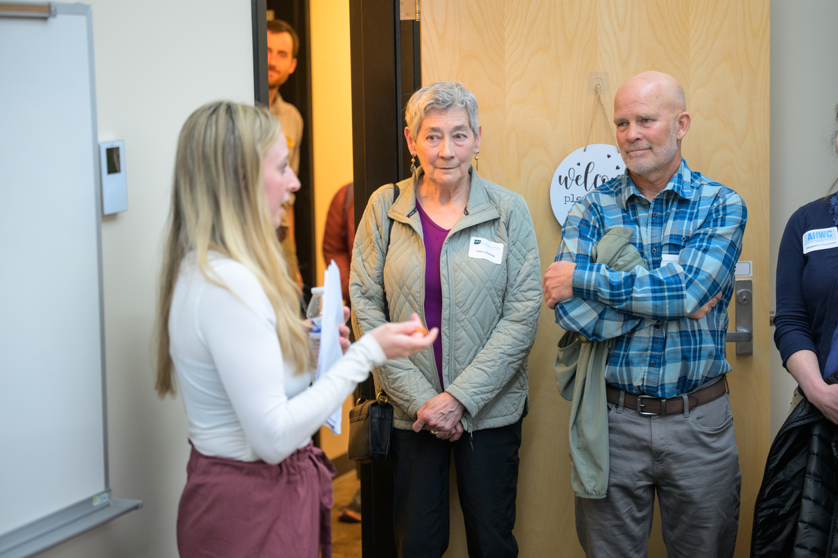 Community members talking with a UAA presenter